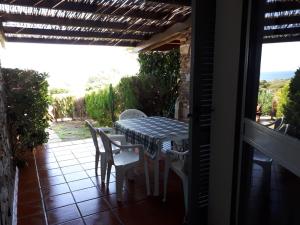 a table and chairs on the balcony of a house at Stintino Living Apartaments in Stintino