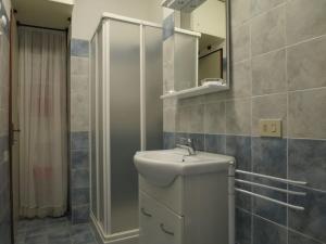 a bathroom with a sink and a mirror and a shower at Stintino Living Apartaments in Stintino