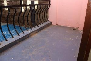 a room with a metal railing next to a wall at Geed Hotel in Nairobi