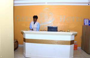 a woman standing at a counter in a hotel room at Geed Hotel in Nairobi