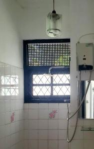 a bathroom with a window and a shower in it at The Colombo House in Battaramulla +13 photos