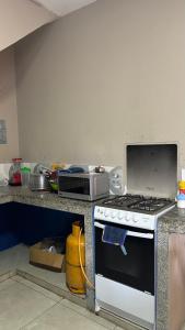 a kitchen with a stove and a microwave on a counter at Casa con Piscina Privada in Salinas +3 photos