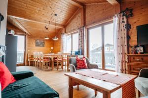 a living room with a couch and a table at Primus Lodge Obertauern in Obertauern