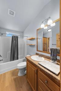 a bathroom with a sink and a toilet and a mirror at Willow Street Cottages in Bluff +40 photos