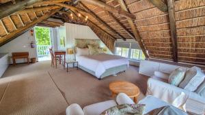 a bedroom with a bed and a living room at Coppull Private Nature Reserve in Stanford