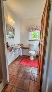 a bathroom with a tub and a toilet and a sink at Coppull Private Nature Reserve in Stanford +31 photos