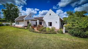 a white house with a yard with grass and trees at Coppull Private Nature Reserve in Stanford