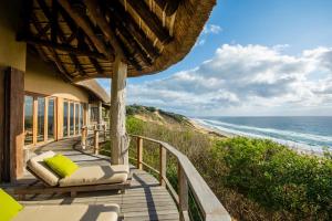 a house with a balcony with a view of the ocean at Monarch Beach Villa in Cimbene