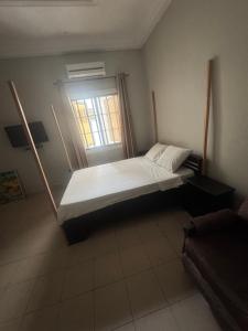 a large bed in a room with a window at Short and long stay in Agblangandan
