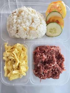 a plastic lunch box with rice and meat and vegetables at Avana Hills Boracay Prime Horizon Suite 103 in Boracay
