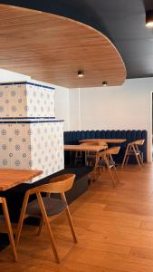 a room with tables and chairs with boxes at Tieflehner Hof Pitztalhaus Hotel in Sankt Leonhard im Pitztal