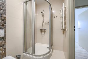 a shower with a glass door in a bathroom at ApartamentyPrzyMorzu Diva 553 in Kołobrzeg +6 photos