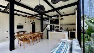 a kitchen and dining room with a table and chairs at Hillstone Luxury Village in Uluwatu