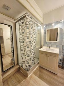 a bathroom with a sink and a shower at La maison d'à côté in Pluherlin