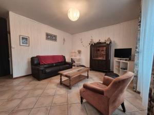 a living room with a couch and a coffee table at La maison d'à côté in Pluherlin