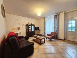 a living room with a couch and a table at La maison d'à côté in Pluherlin +8 photos