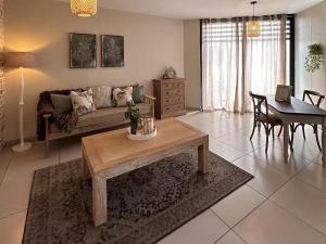 a living room with a couch and a table at Wild Olive 65 Farmhouse Style in Windhoek