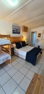a bedroom with two beds in a room at Starboard Self Catering - St Helena Bay in Stompneusbaai