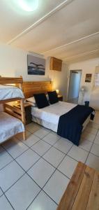 a bedroom with two beds in a room at Starboard Self Catering - St Helena Bay in Stompneusbaai