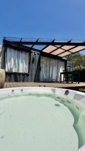 a large pool of water in front of a house at Cabana ECO - Teresópolis in Teresópolis +8 photos