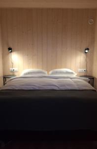 a bedroom with a large bed with two pillows at Oddnýjarhús in Höfn