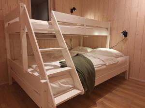 a white bunk bed with a ladder in a room at Oddnýjarhús in Höfn