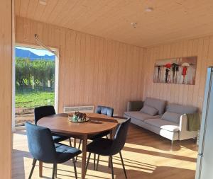 a living room with a table and chairs and a couch at Oddnýjarhús in Höfn