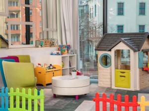 a play room with a toy house and a table at Ibis Styles Wroclaw Centrum in Wrocław