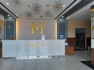 a lobby with a maughan suites sign on the wall at Borneo Hideaway - Manhattan Suites, ITCC in Penampang