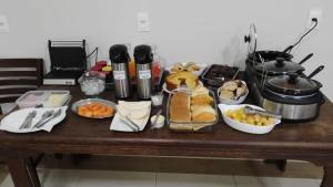 a table with a bunch of food on it at Hotel Serra dos Cristais in Cristalina