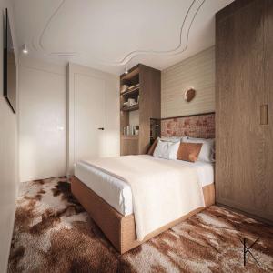 パリにあるJills Hôtelの部屋の中に大きなベッドがある寝室