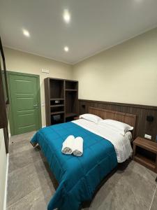 a bedroom with a large bed with two hats on it at Andrea House in Naples