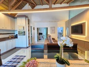 eine Küche und ein Wohnzimmer mit einem Glastisch in der Unterkunft Casa Praia Alegre in Penha