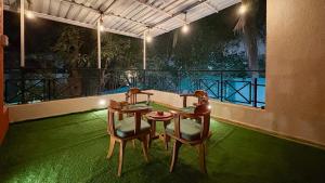 a room with a table and two chairs and a balcony at CocoAura - Tropical Luxury Villa with Pool&Jacuzzi in Utan