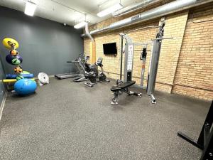 a gym with several treadmills and machines in a room at Loft on Lake Ave in Duluth