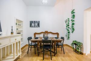 a dining room with a wooden table and chairs at BHR - La Finestra su Spoleto in Spoleto