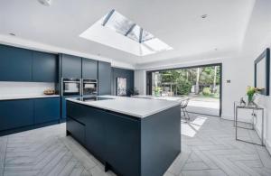 a kitchen with blue cabinets and a white counter top at Kiwi Pines forest retreat! in Saint Leonards