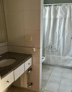 a bathroom with a sink and a shower at Tempo Apart in La Plata