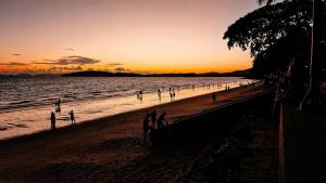 a group of people on the beach at sunset at Nomads Ao Nang in Ao Nang Beach