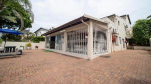 a building with a gate on a brick driveway at 1 Seabreeze Cottage in Durban +3 photos