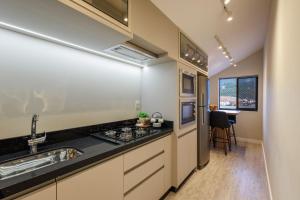 a kitchen with a sink and a stove at Apartamento 401 wiithhoeftf in Pomerode