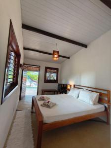 a bedroom with a large bed in a room at Villa Tarifa Icaraizinho in Amontada +47 photos