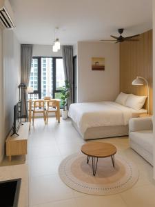 a hotel room with a bed and a table at 22Macalisterz Georgetown Studio in George Town