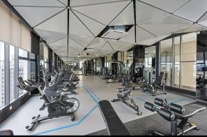 a gym with rows of cardio equipment in a building at Central Georgetown Studio with Nespresso Machine in George Town