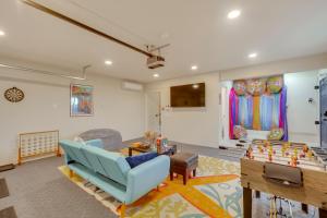 a living room with a blue couch and a table at The Maharaja Retreat with Hot Tub and EV Charger! in Yucca Valley