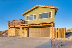 a house with a balcony and a garage at The Maharaja Retreat with Hot Tub and EV Charger! in Yucca Valley