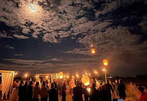 a group of people standing in front of a crowd at night at Agriturismo Valle Ca' del Lovo in Carlino +79 photos
