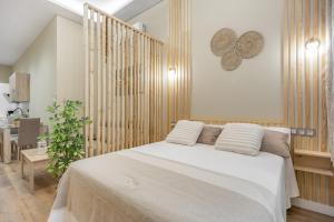 Ένα ή περισσότερα κρεβάτια σε δωμάτιο στο Apartamentos Brisas de Cádiz 2