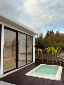 a swimming pool on the deck of a house at Aluna Villa Kintamani - Private villa & Hot spring pool in Kubupenlokan +13 photos