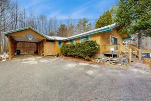 a yellow house with a porch and a driveway at The Prospect House in Bethlehem